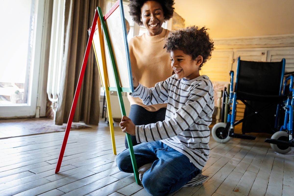 An occupational therapy practitioner working with a child on fine motor skills