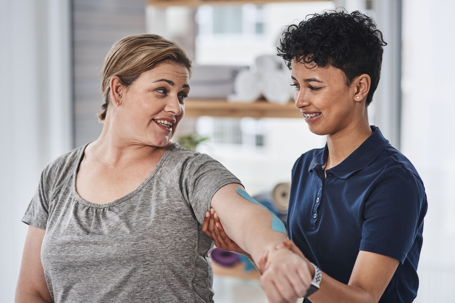 An occupational therapy assistant guiding a patient through a strengthening exercise